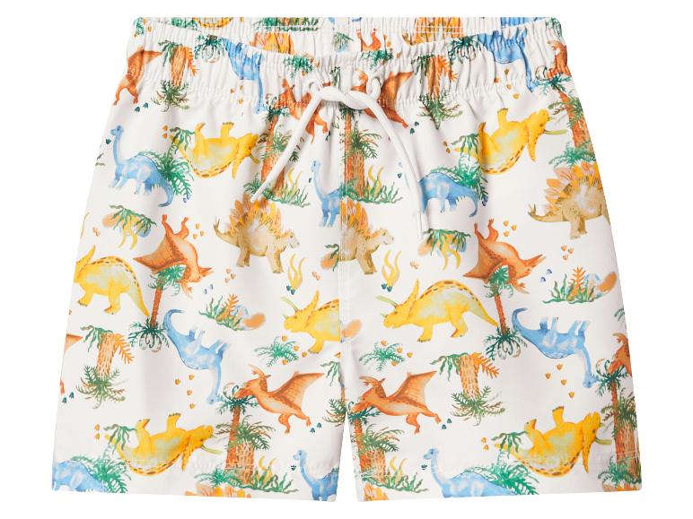 Weiße Kinder-Badeshorts mit farbenfrohem Dinosaurier- und Palmenmuster.