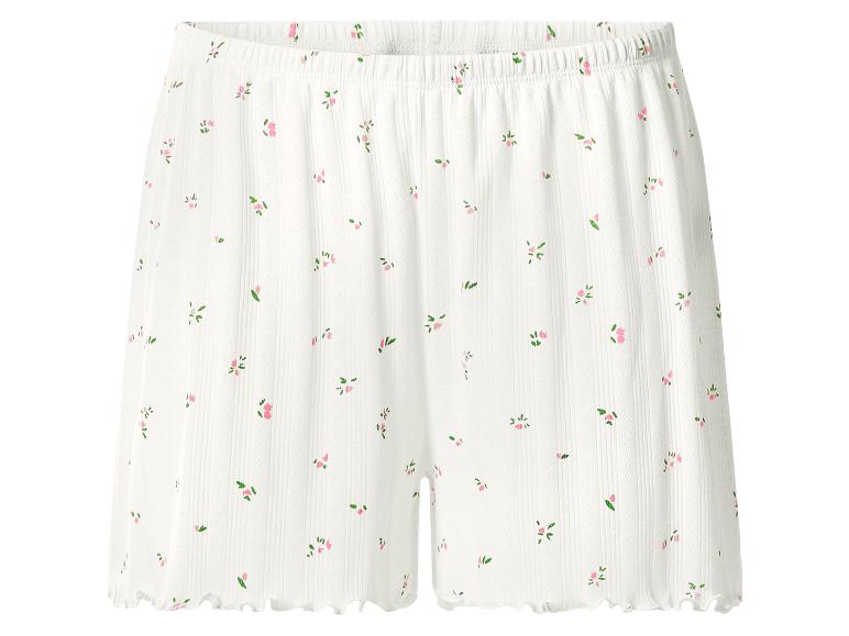Weiße gerippte Shorts mit zartem rosa Blumenmuster und Rüschensaum.