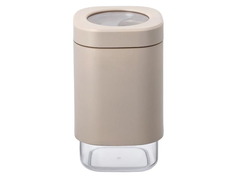 Ein beigefarbener Gewürzbehälter mit transparentem Deckel.