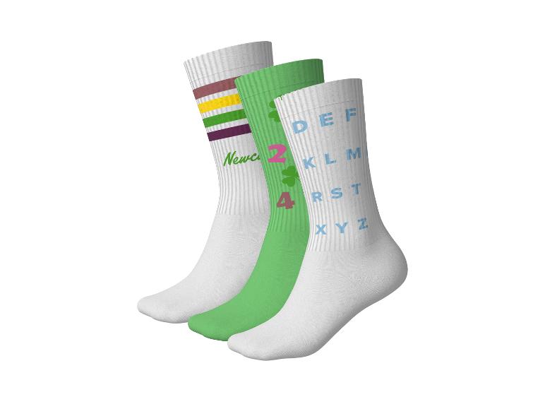 Drei Paar weiße und grüne Socken mit Streifen, Buchstaben und Zahlen.