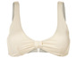 Ein cremefarbener Bikini-BH mit Schleife.