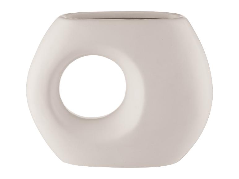 Ein weißer, runder, ovaler Topf mit einem Loch in der Mitte.