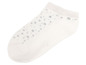 Weiße Socke mit silbernen Punkten.