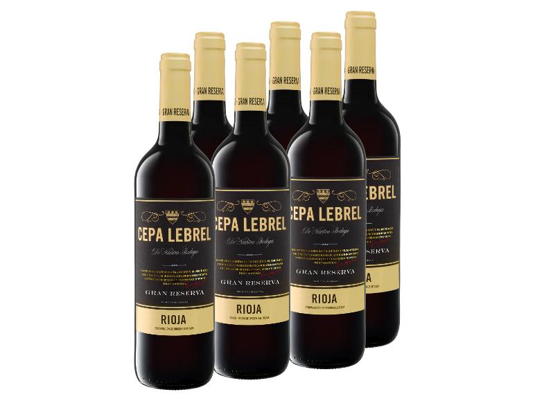 Sechs Flaschen Rotwein mit schwarzen und goldenen Etiketten, mit „Gran Reserva Rioja“.