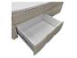 Boxspringbett mit offener Aufbewahrungsschublade und weißem Matratzentopper.