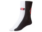 Weiße und schwarze Socken mit 'Lacoste' Logo.