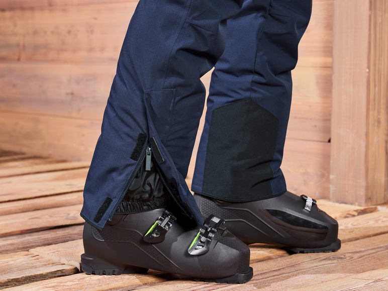 Skischuhe und -hose mit Reißverschlüssen.