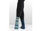 Beine in dunklen Leggings, ein Fuß in einem gestreiften Socken, der andere in einem einfarbigen blauen Socken.