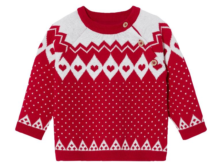 Ein roter Strickpullover mit weißem Muster und Herzen.