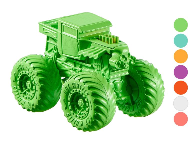 Grüner Monstertruck mit Totenkopf-Design und großen Reifen.