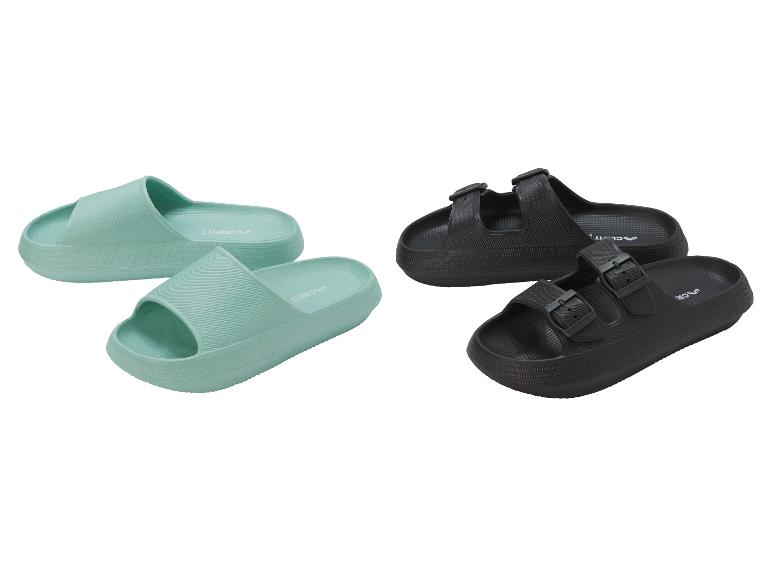 Grüne Pantoletten und schwarze Sandalen auf weißem Hintergrund.