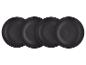 Vier schwarze, texturierte Keramik-Essteller, leicht überlappend.