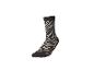 Socke mit Zebramuster in Schwarz- und Beigetönen.