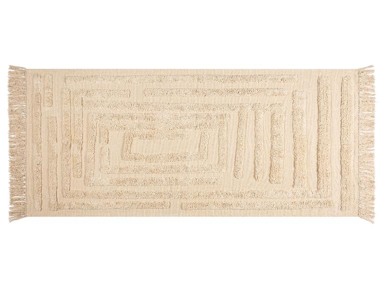 Beiger rechteckiger Teppich mit erhabenem geometrischem Muster und Fransen.