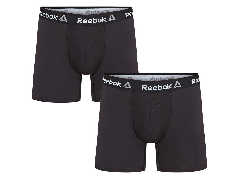 Zwei Paar schwarze Reebok Boxershorts mit weißen Logos an den Bund.