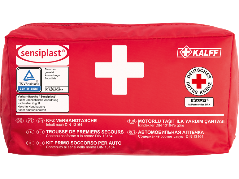 Rote Verbandtasche mit weißem Kreuz, TÜV-Zertifizierung und mehrsprachigem Text.