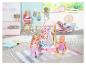 BABY born Puppen in einem Spielzimmer mit Kleiderständer, Hochstuhl und Wippe.