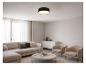 Modernes Wohnzimmer mit modularem Sofa, rundem Couchtisch und Sesseln, beleuchtet von einer schwarzen Deckenleuchte.