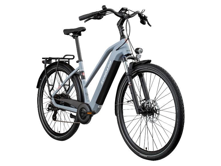 Graues E-Bike mit Gepäckträger, Schutzblechen und Vorderlicht.