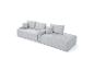 Hellgraues modulares Cordsofa mit Kissen und Chaiselongue-Abschnitt.