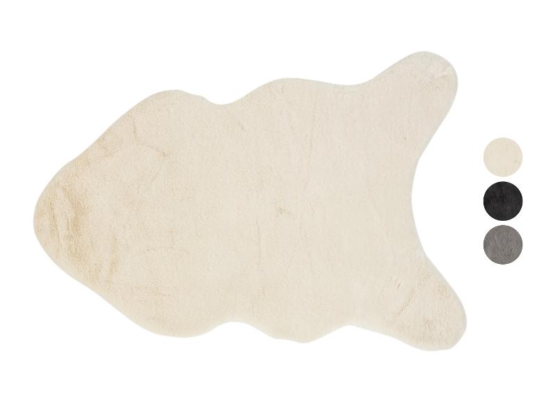 Ein cremefarbener, langhaariger Schafspelzteppich.