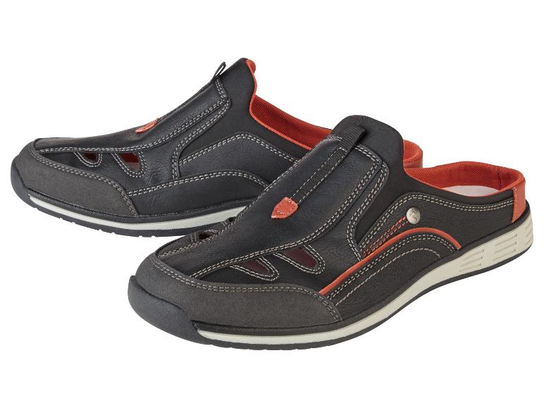 Schwarze offene Sandalen und Pantoletten mit orangenen Details.