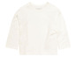 Ein weißes Langarmshirt für Babys von Milkbutton.