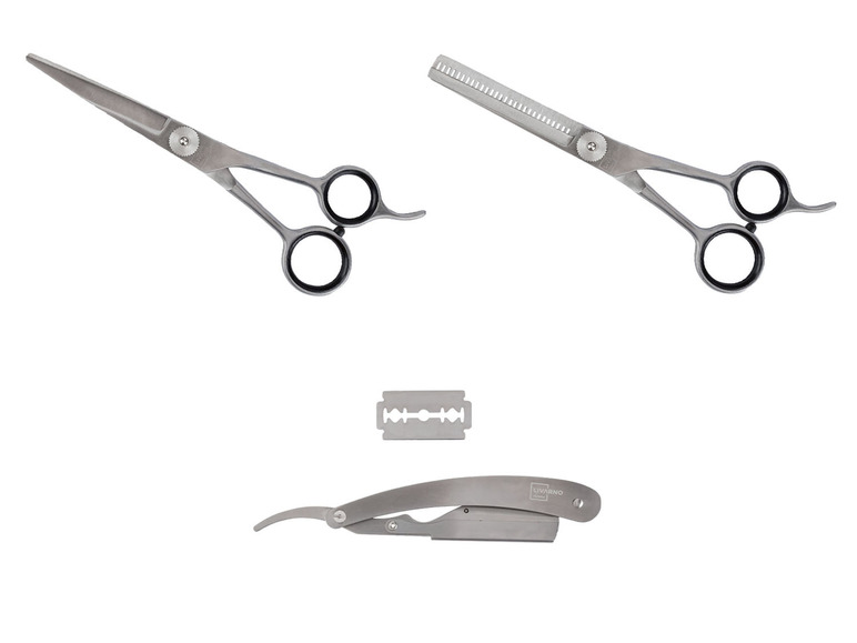 Zwei Scheren, ein Rasiermesser und eine Klinge.