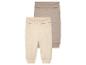 Zwei Baby-Leggings in Beige und Taupe aus weichem Stoff.