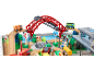 Holzeisenbahn-Set mit roter Brücke, Krankenwagen, Bus und verschiedenen Verkehrsschildern.