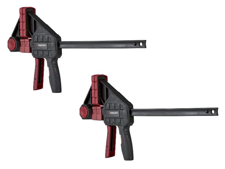 Zwei rot-schwarze Einhandzwingen mit Schnellspannmechanismus.