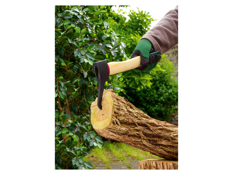 Eine Hand mit einer Axt schlägt auf einen Holzstamm.
