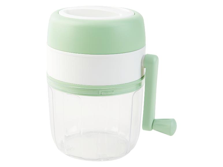 Ein hellgrüner Hand-Zerkleinerer mit durchsichtigem Behälter.