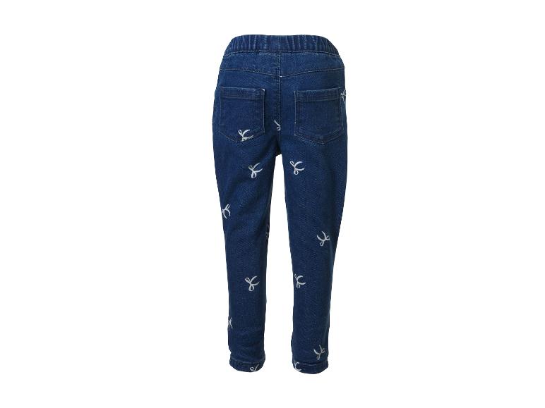 Blaue Mädchenjeans mit weißem Schleifenmuster, Rückansicht.