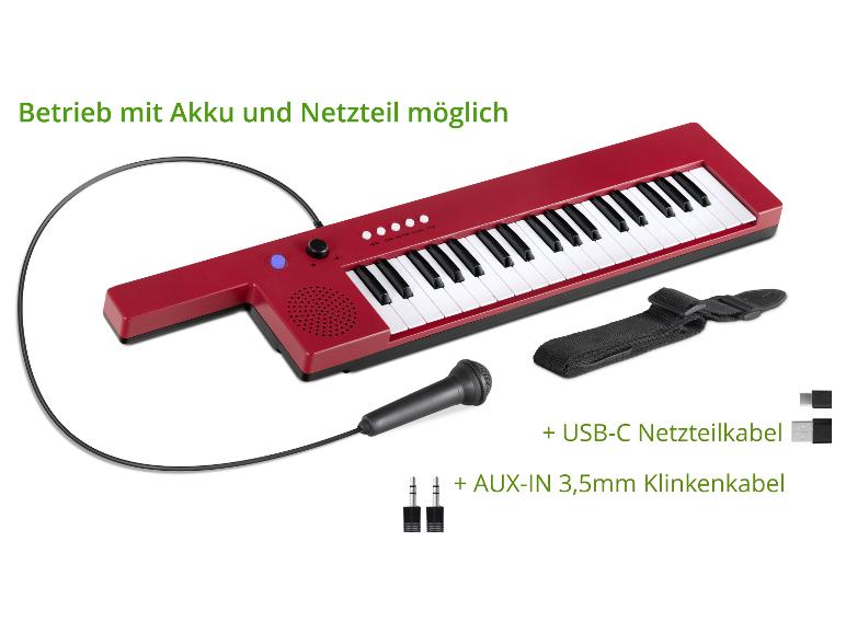 Rotes elektronisches Keyboard mit Mikrofon, USB-C-Kabel und AUX-Kabel.