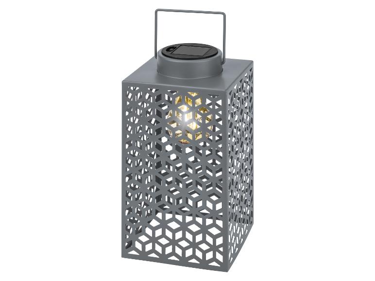 Graue Solarlaterne mit geometrischem Design und warmem Licht.