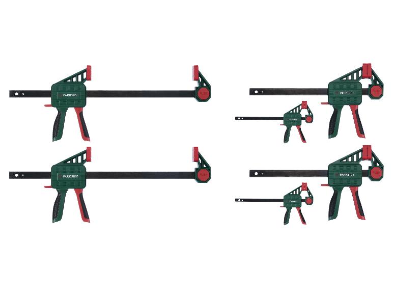 Vier Schraubzwingen, zwei große und zwei kleine, auf weißem Hintergrund