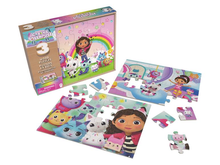 Set aus 3 Holzpuzzles mit Zeichentrickfiguren, teilweise zusammengebaut.