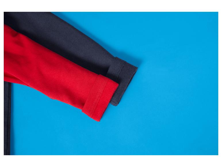 Zwei Hemdärmel, einer rot und einer dunkelgrau, auf blauem Hintergrund.