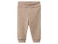 Beige gerippte Babyhose mit umklappbarem Bund.