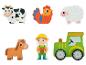 Bauernhofspielzeug: Kuh, Hahn, Schaf, Pferd, Traktor und Bauer.