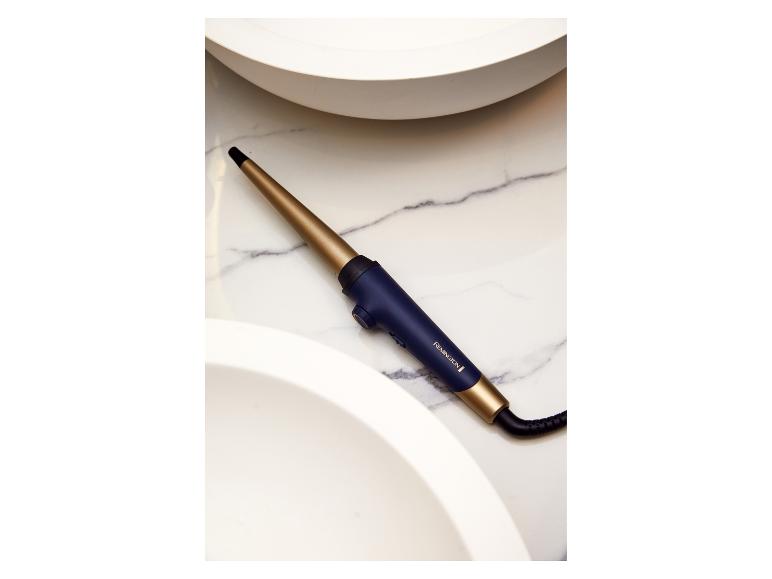 Remington Lockenstab in Gold und Dunkelblau auf Marmor.