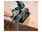 Person mit Handschuhen, die eine Kreissäge mit Staubsauger an Holz verwendet.