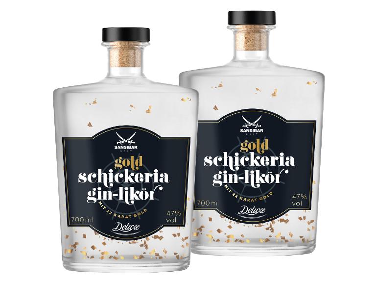 Zwei Flaschen Gin-Likör mit Goldflocken, schwarzen Etiketten und Korken.