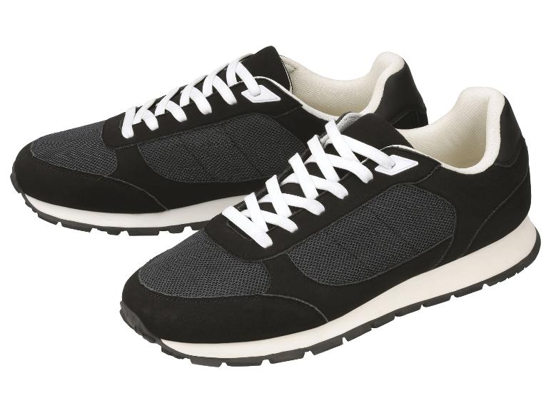 Ein Paar schwarze Sportschuhe mit weißen Schnürsenkeln und Sohlen.