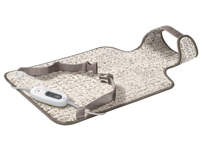 Weiße, flauschige Heizdecke mit Sanitas Fernbedienung und Befestigungsgurten.