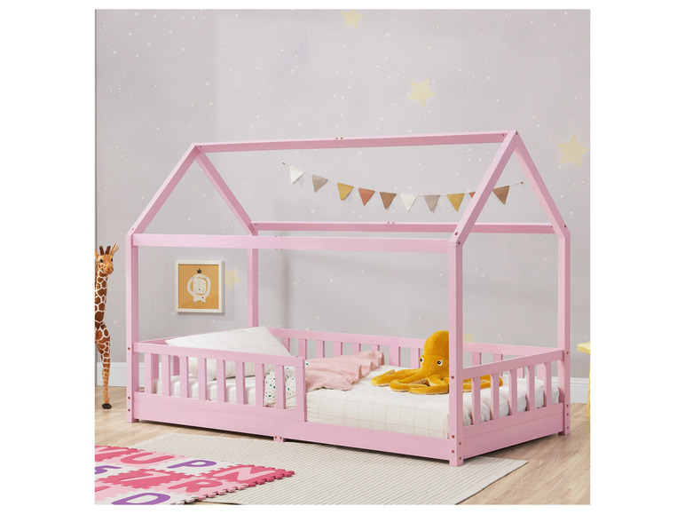 Ein rosafarbenes Hausbett für Kinder mit Matratze und einem Tintenfisch-Plüschtier.