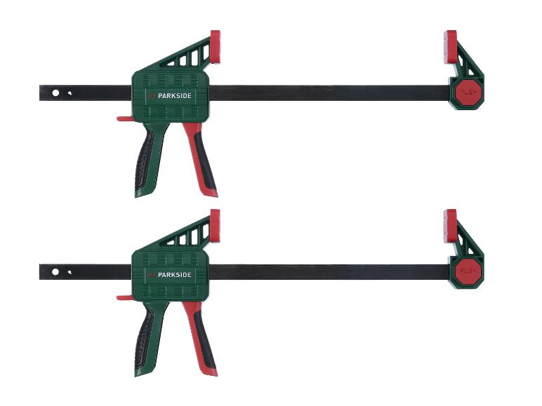 Zwei grüne und rote Holzklemmen mit schwarzen Griffen