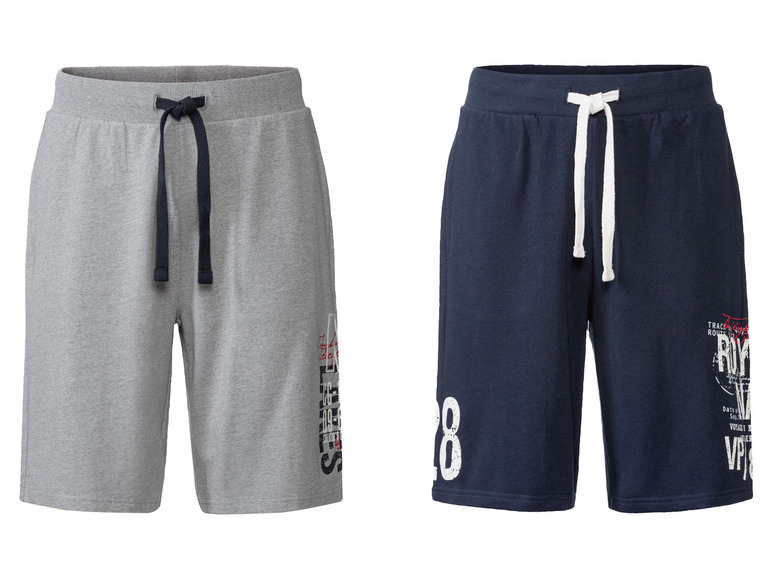 Zwei kurze Hosen, eine graue mit schwarzen Bändern und eine dunkelblaue mit weißen Bändern.