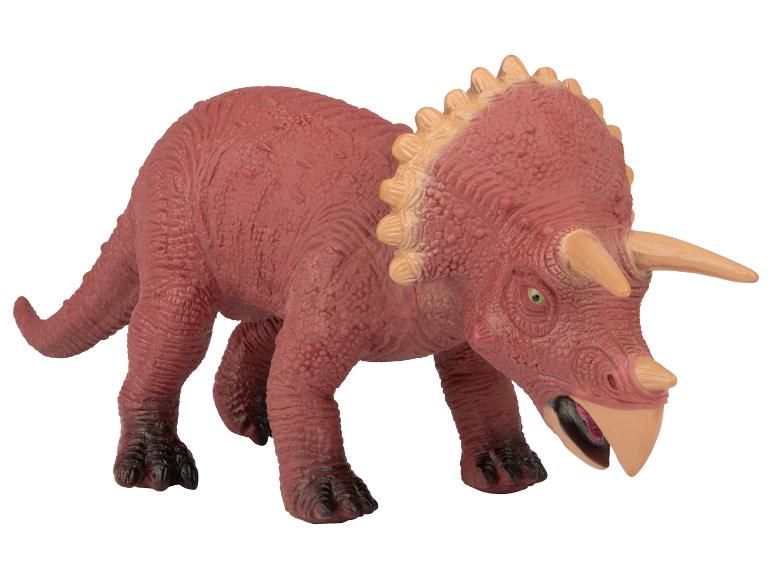Ein rotes Plastik-Dinosaurierspielzeug, ein Triceratops.